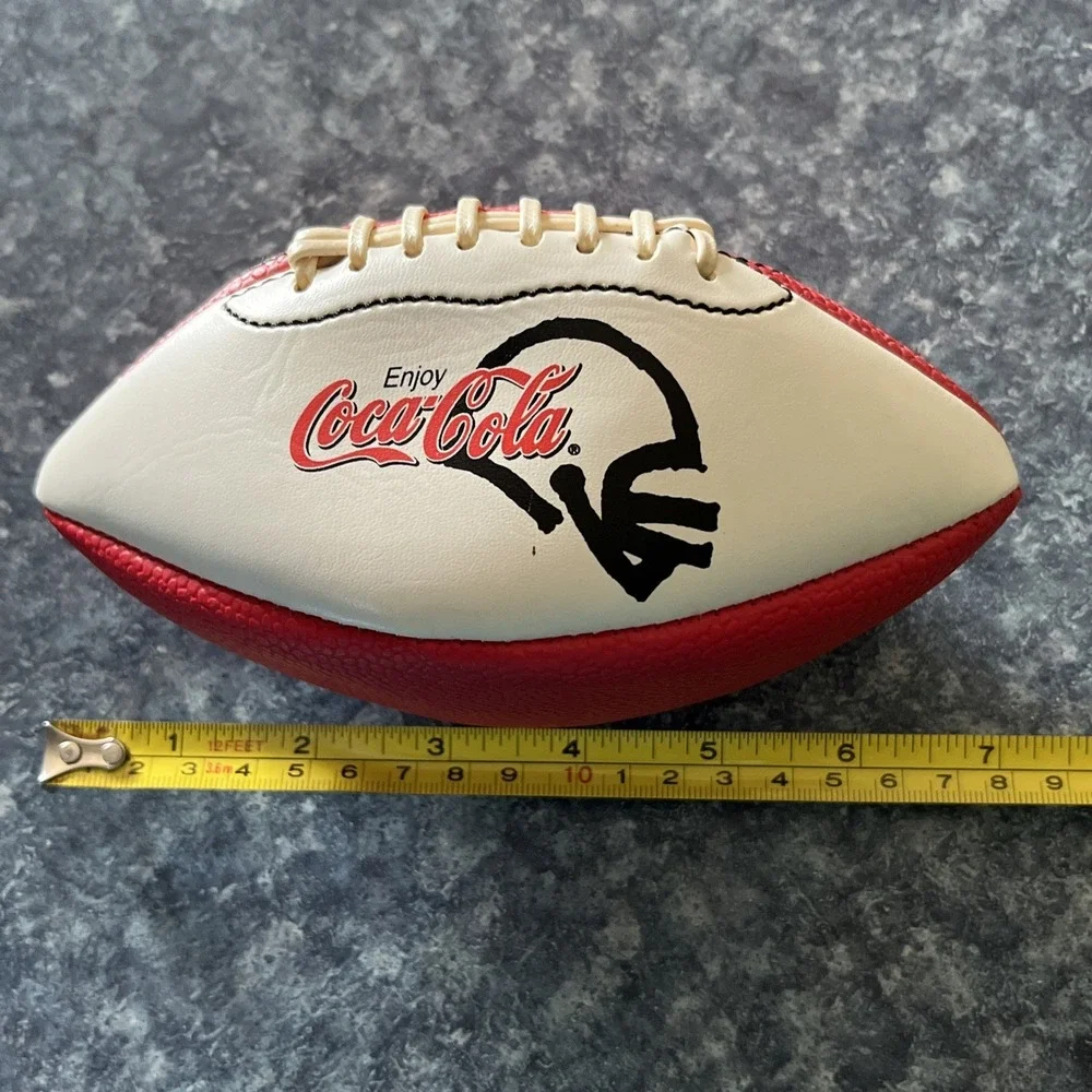 2 Collectible Coca Cola Mini Footballs. (1-leather, 1- foam) approx. 7 inches